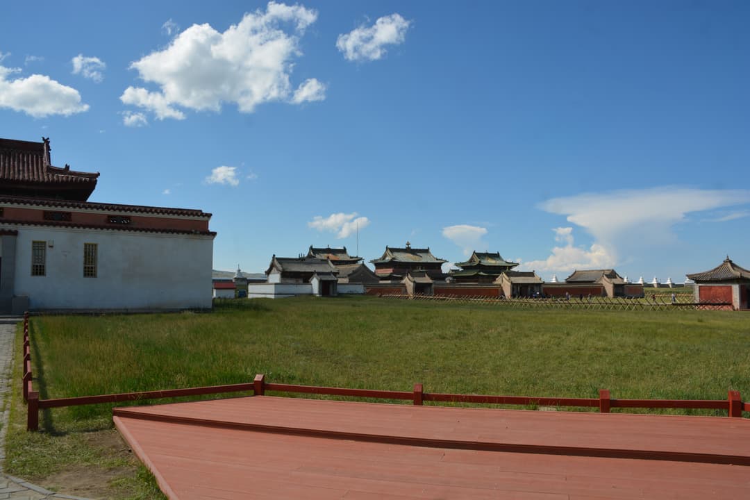 Wide-angle view across the grassy grounds of Erdene Zuu Monastery.