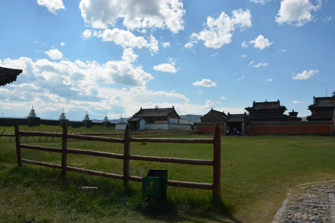Wide exterior view of Erdene Zuu Monastery grounds, temples, and stupa wall.