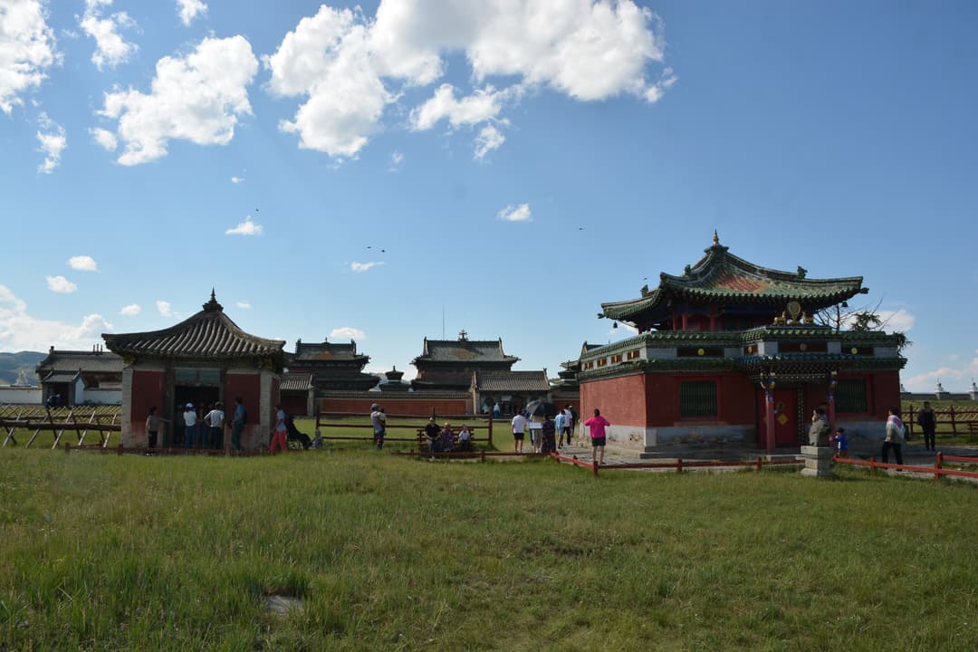 Wide exterior view of Erdene Zuu Monastery temples under a bright sky.