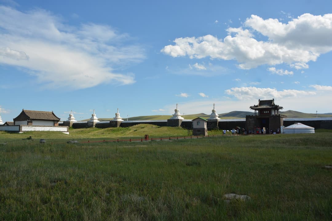 Wide view of the stupa-studded perimeter wall and entrance gate tower.