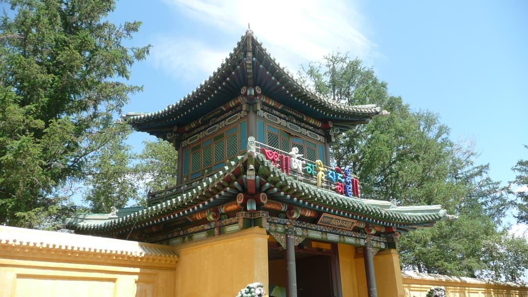 Low-angle daytime view of the ornate entrance pavilion at Gandan Monastery.