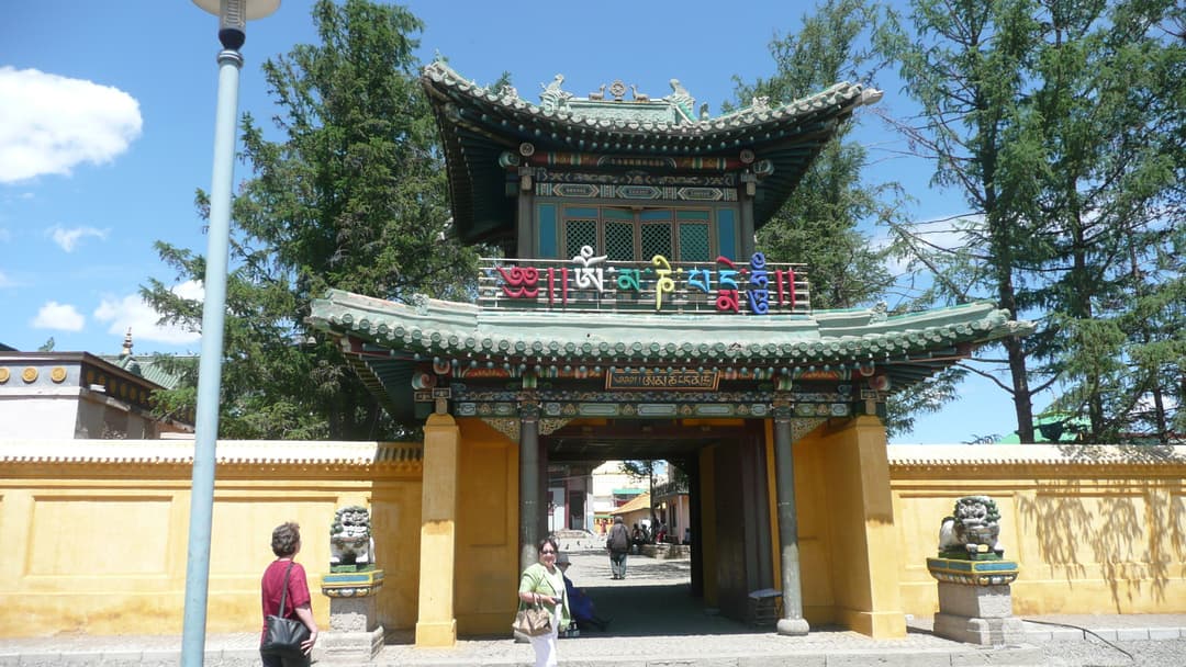 Front entrance gate of Gandantegchinlen Monastery in daylight.