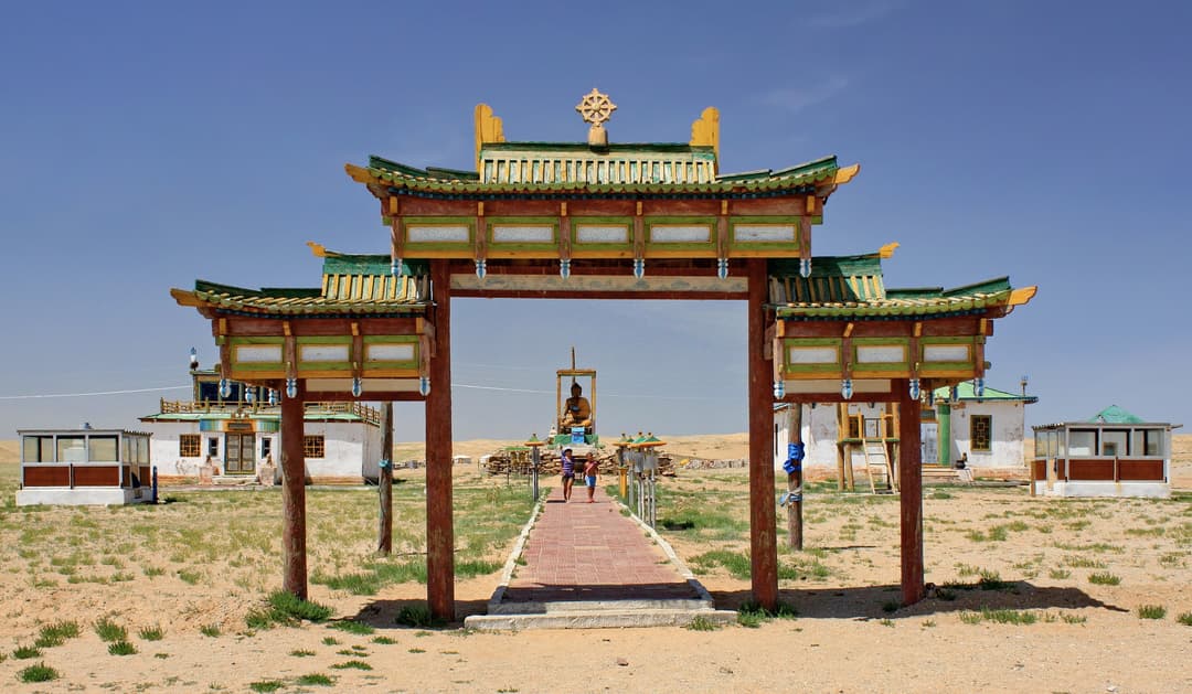 Front view of the ornate wooden entrance gate at Khamarin Hiid.