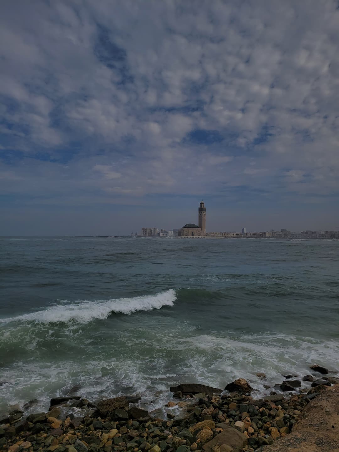Distant view of the Hassan II Mosque across the Atlantic Ocean.