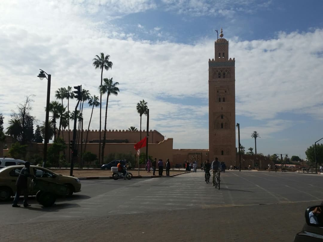 Street-level view of the Koutoubia Mosque minaret and surrounding avenue.
