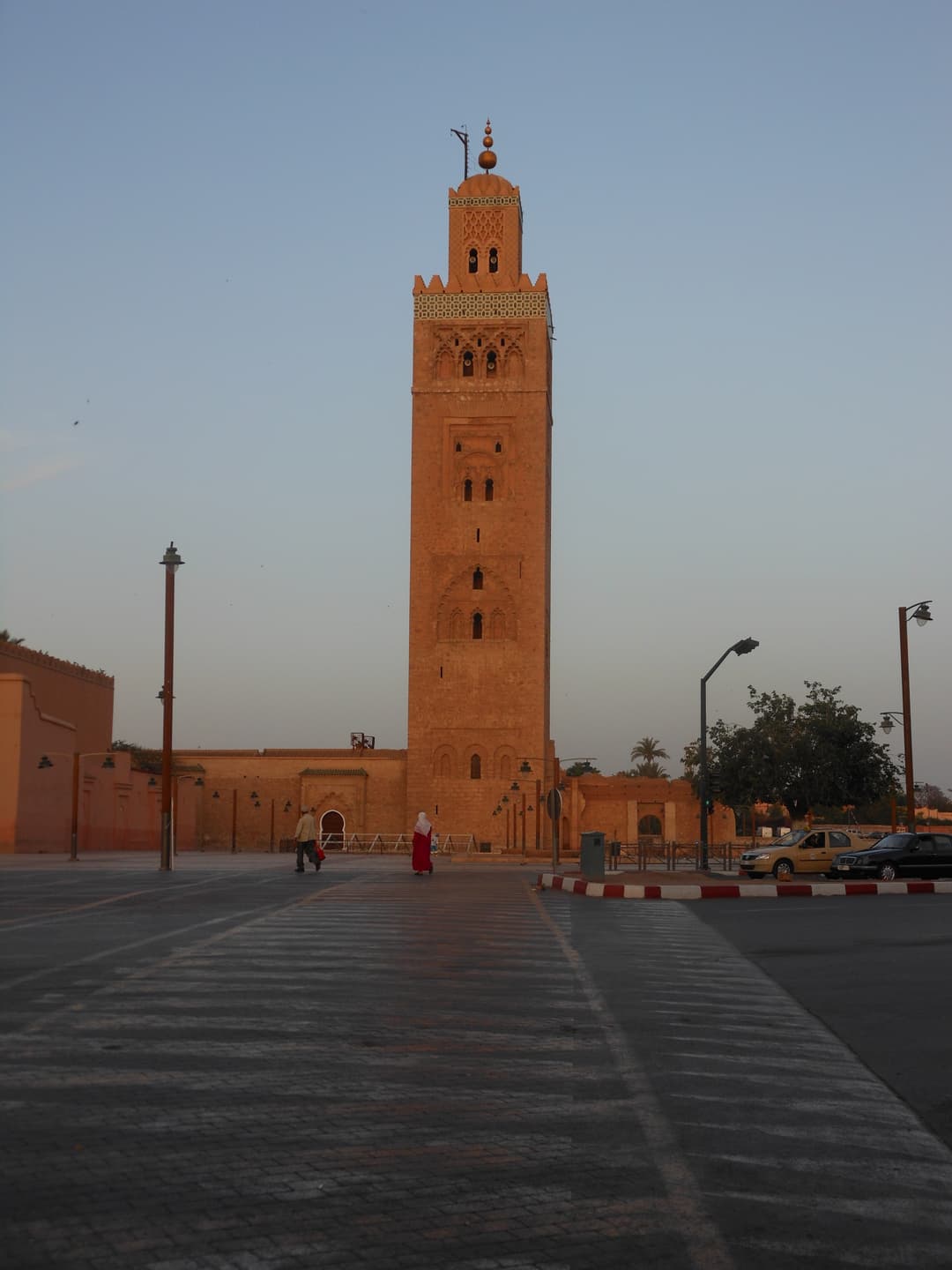 Minaret of the Koutoubia Mosque seen across the plaza at dusk