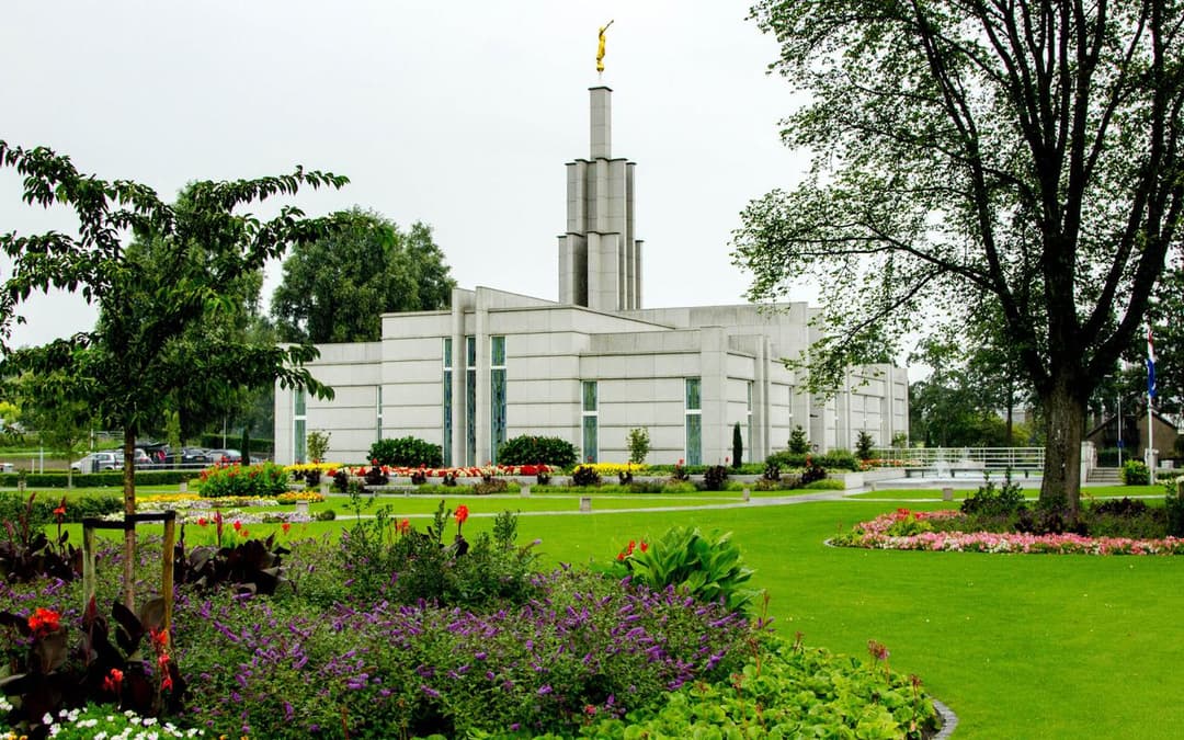 Exterior view of The Hague Netherlands Temple and its manicured gardens.