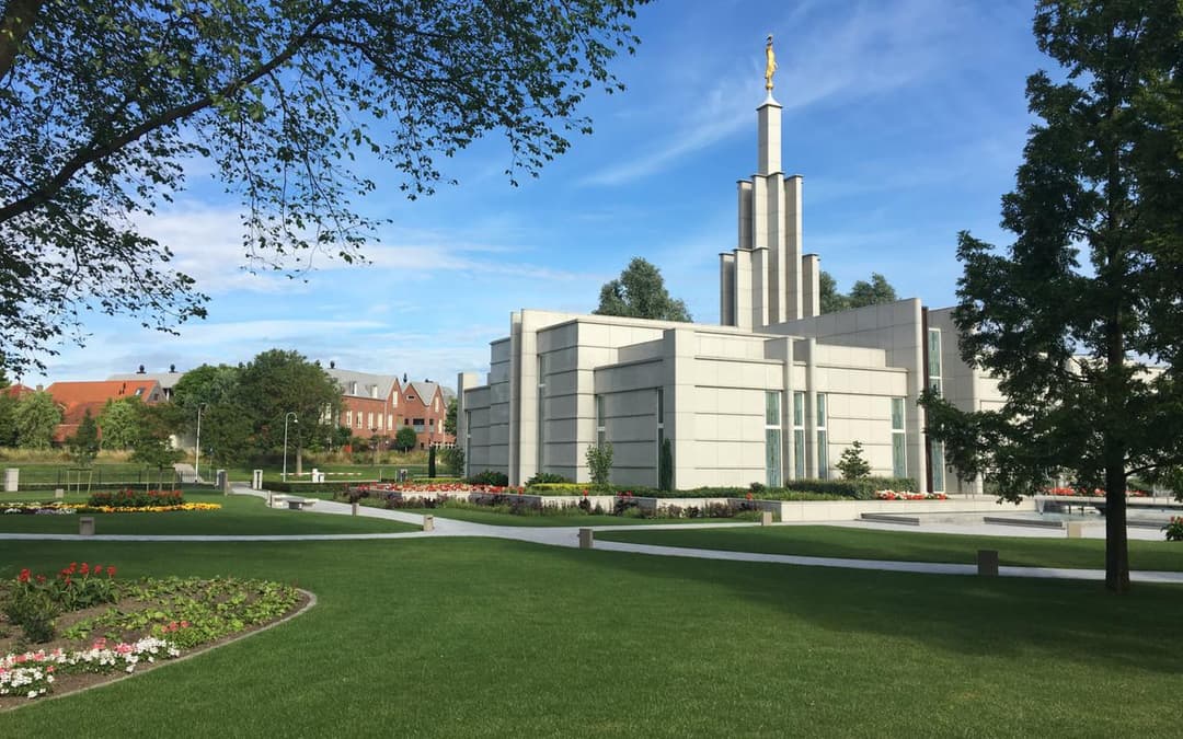 Wide exterior view of The Hague Netherlands Temple and manicured grounds.