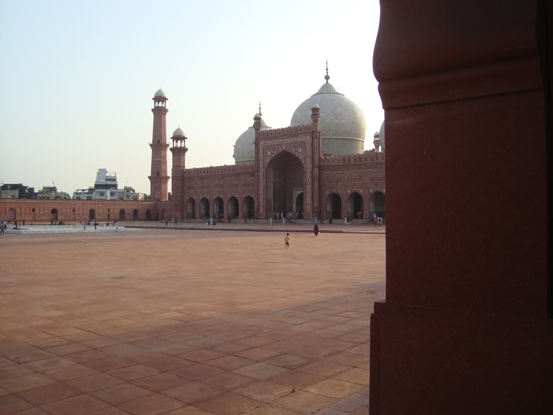 Courtyard view toward the main prayer hall and marble domes