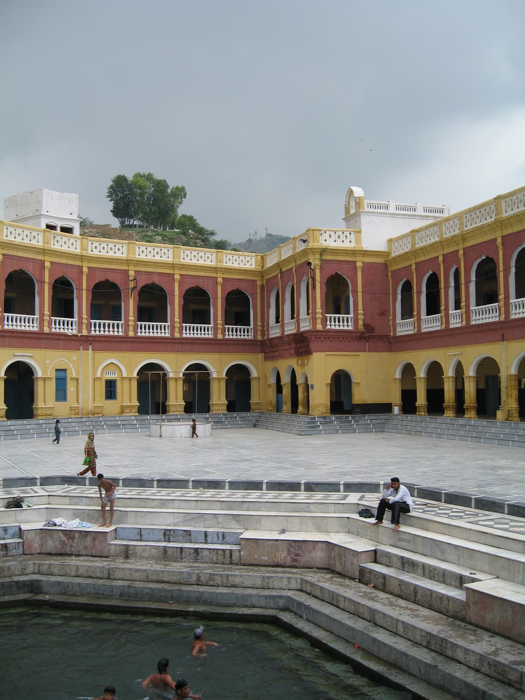 The sacred pool (sarovar) and arched courtyard of Gurdwara Panja Sahib.