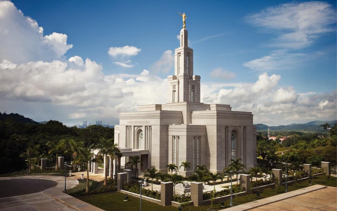 Panama City Panama Temple exterior, Angel Moroni statue, cloudy blue sky.