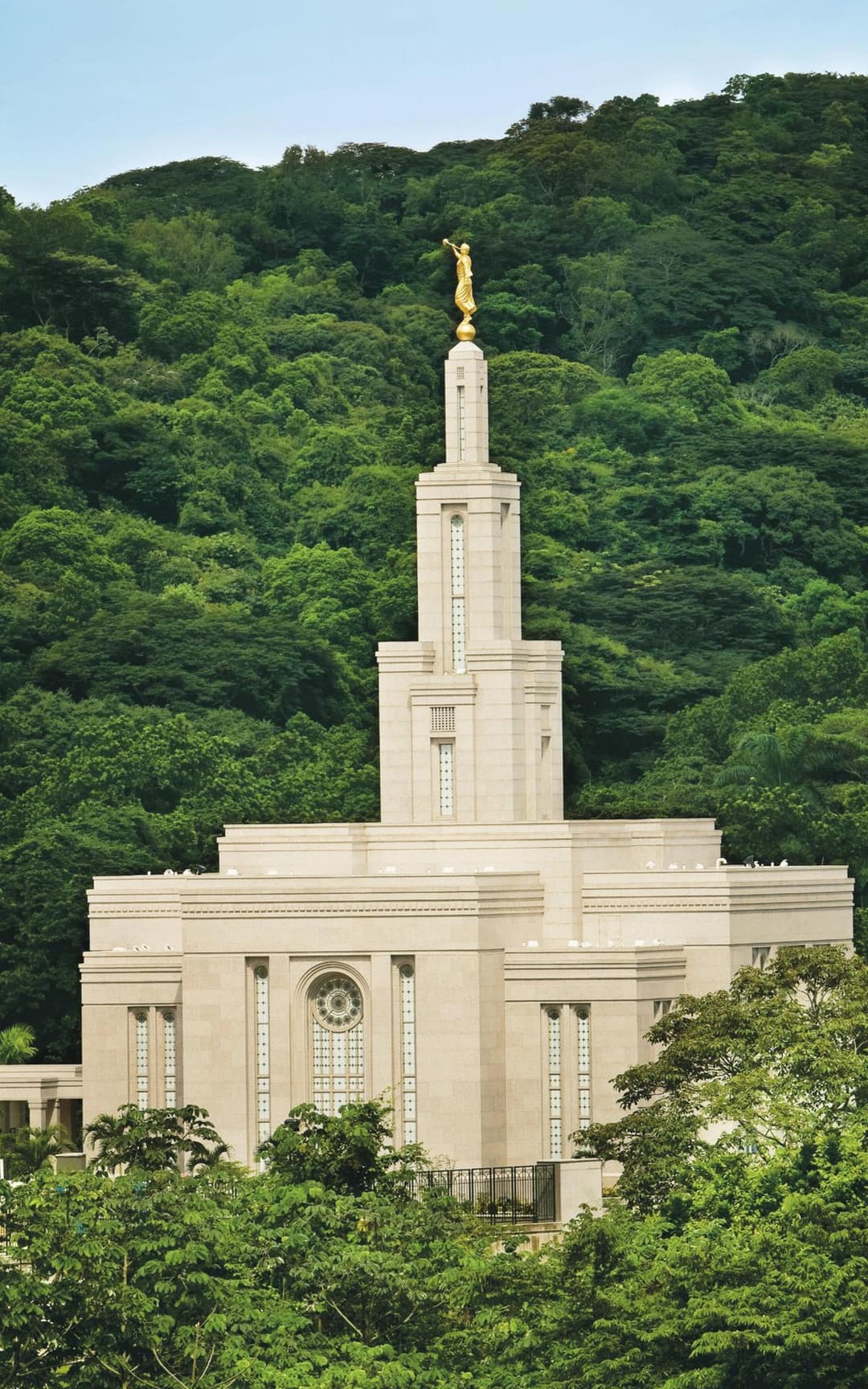 Panama City Panama Temple with Angel Moroni, backed by dense green forest.