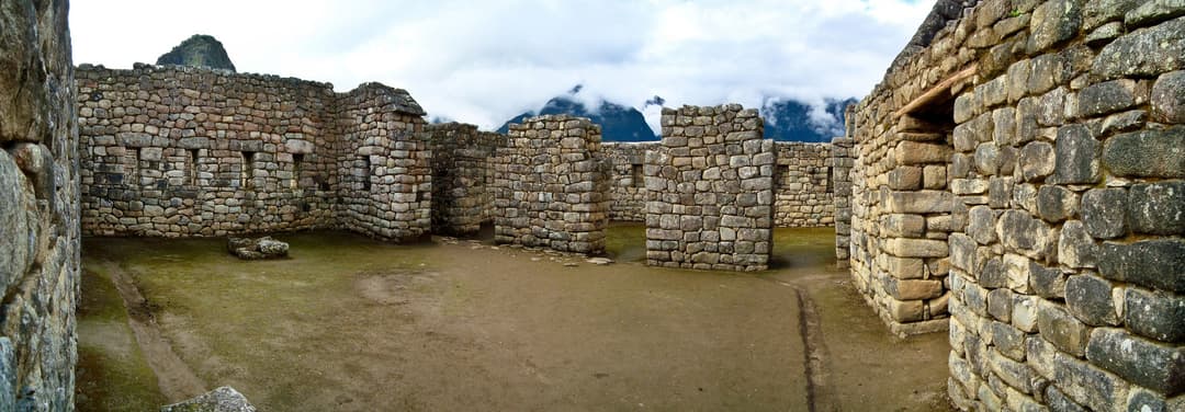 Panoramic view of stone enclosures with trapezoidal niches at Machu Picchu