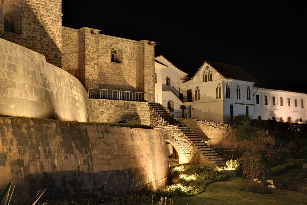 Curved Inca wall and gardens of Qorikancha illuminated at night