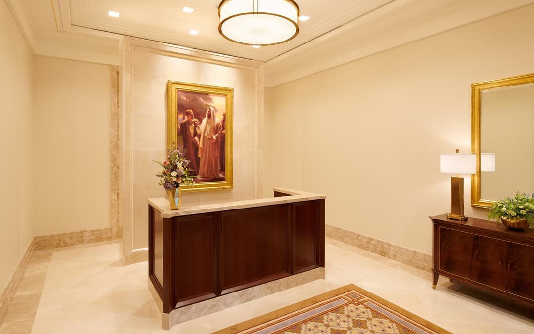 Interior: reception area with religious painting, desk, and console.