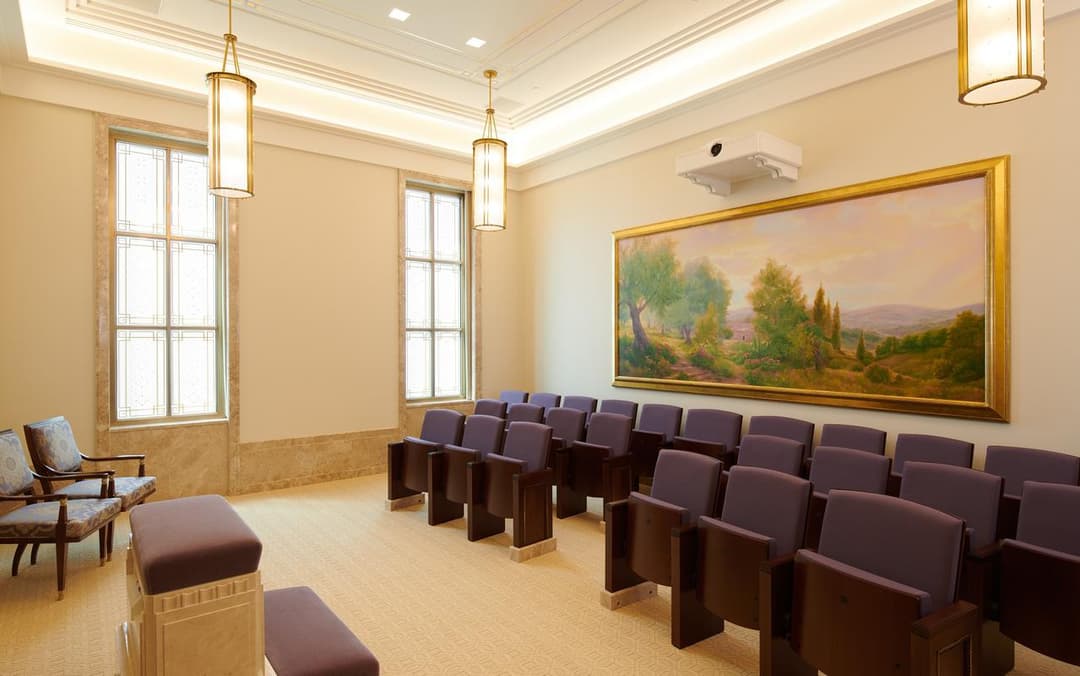 Lisbon Portugal Temple interior: room with purple seating, windows, and landscape art.