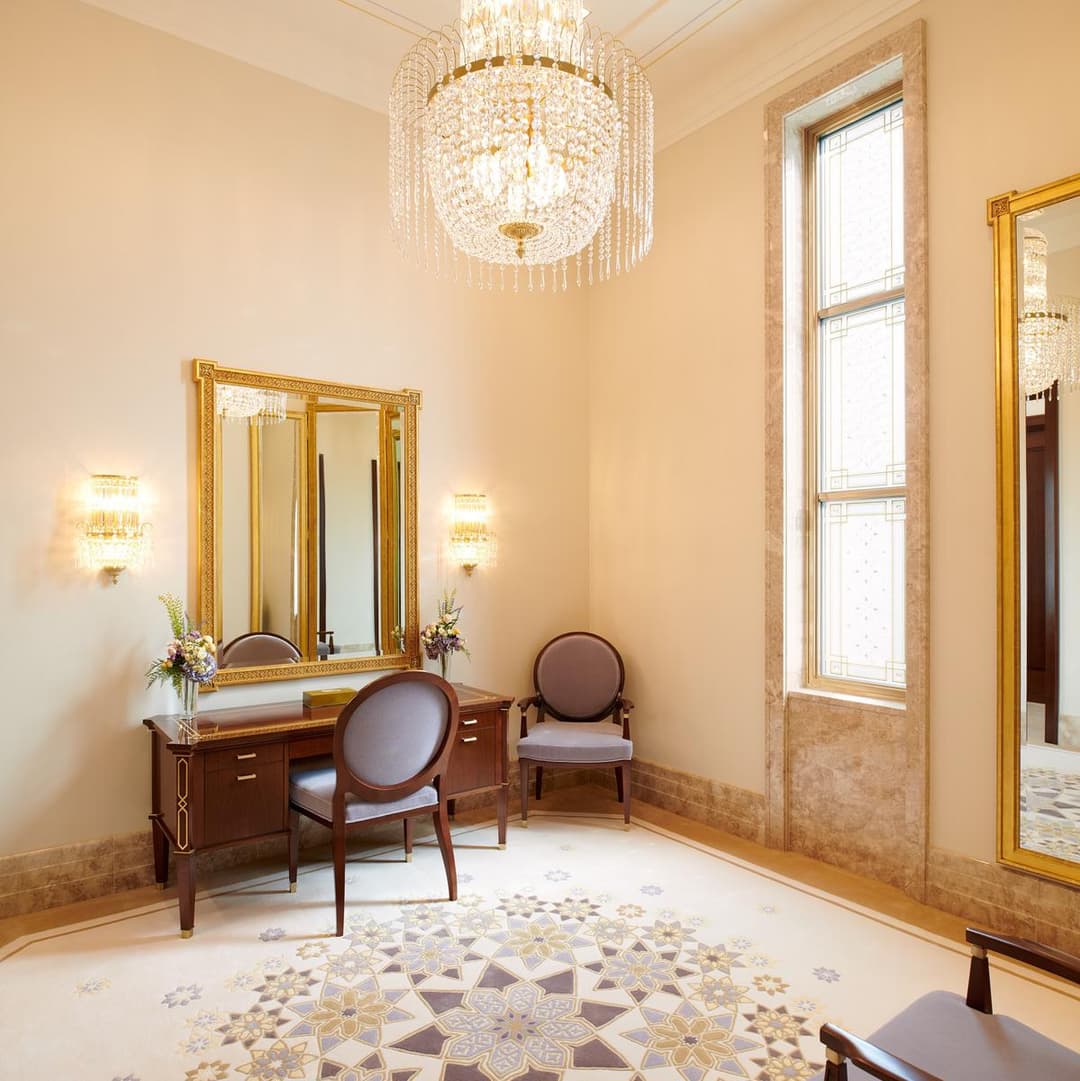 Lisbon Temple interior with chandelier, desk, chairs, mirror, and rug.