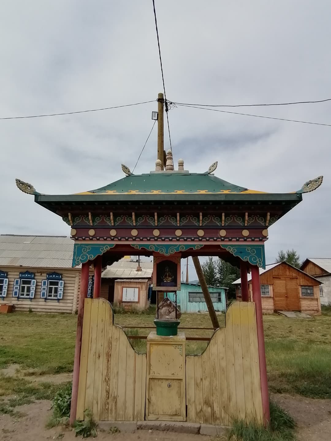 Front view of an ornate wooden shrine pavilion at Ivolginsky Datsan.