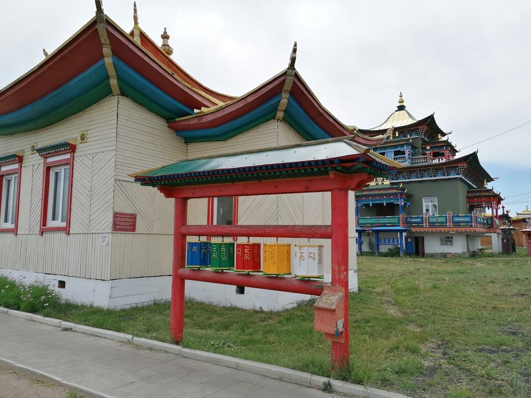 Colorful prayer wheels outside timber temples at Ivolginsky Datsan.