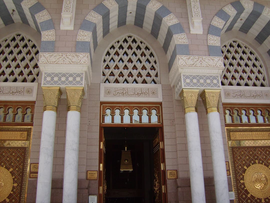 Ornate doorway at Al-Masjid an-Nabawi, with marble columns and patterned screen.