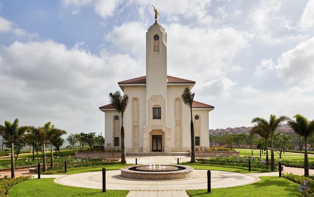 Front view of Durban South Africa Temple with Angel Moroni, fountain, and gardens.