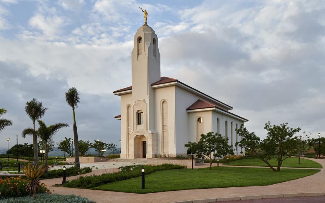 Durban South Africa Temple exterior at dusk, with Angel Moroni and gardens.