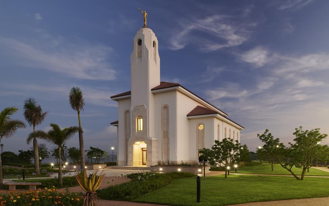 Durban South Africa Temple exterior at twilight, with Angel Moroni and gardens.
