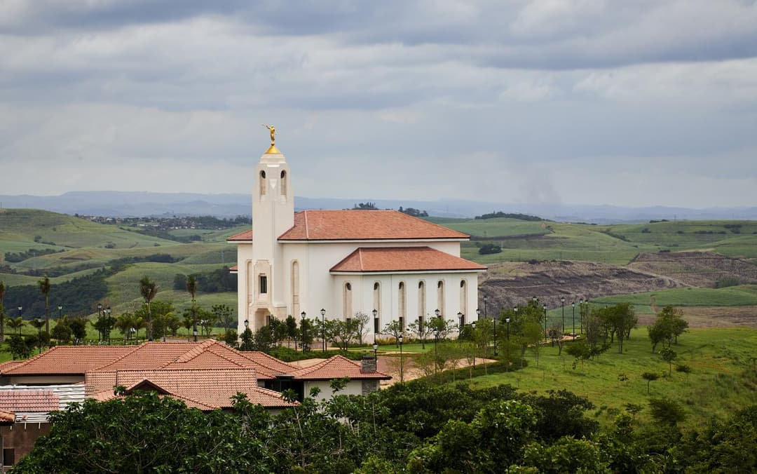 Durban South Africa Temple, golden Angel Moroni, green hills, overcast sky.