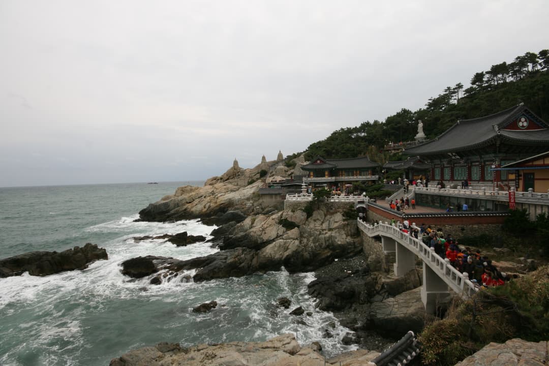 Wide-angle view of Haedong Yonggungsa Temple built on coastal granite cliffs.