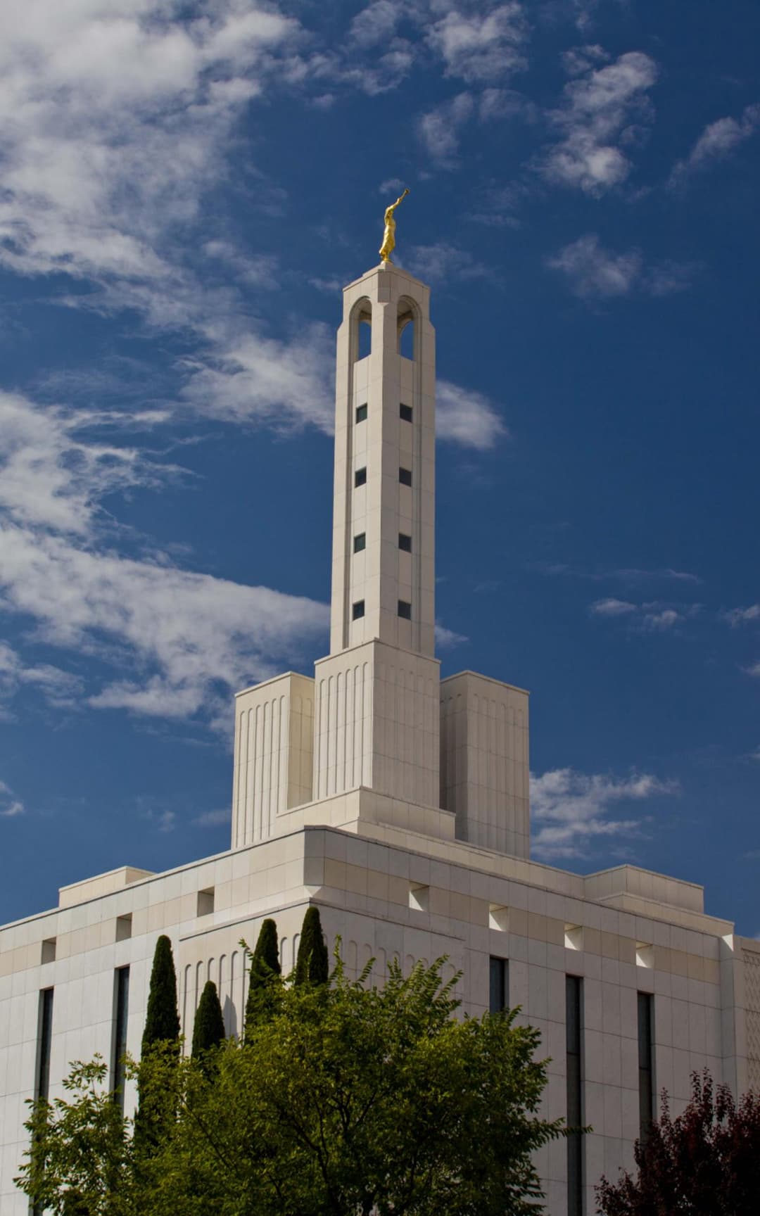 The temple grounds are beautifully landscaped with trees and flowers.