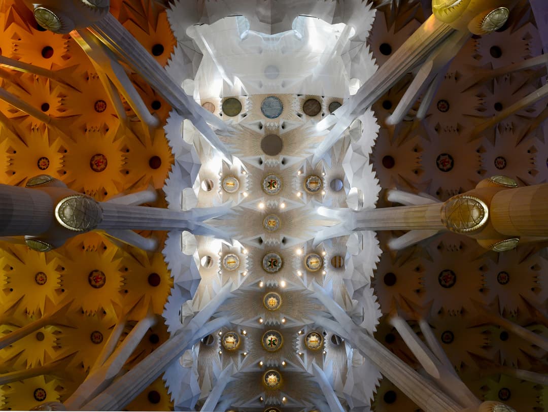 Interior view looking up at the vaulted ceiling of La Sagrada Família.