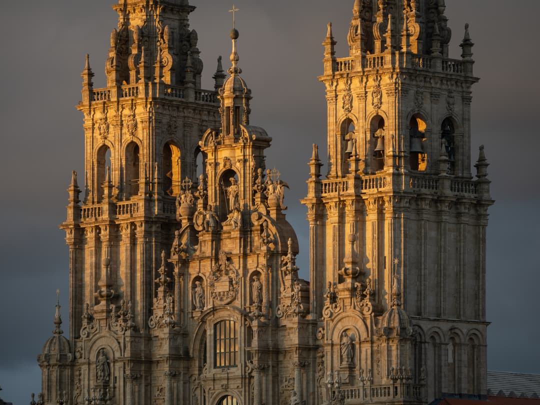 Close-up of the Obradoiro facade towers at golden hour