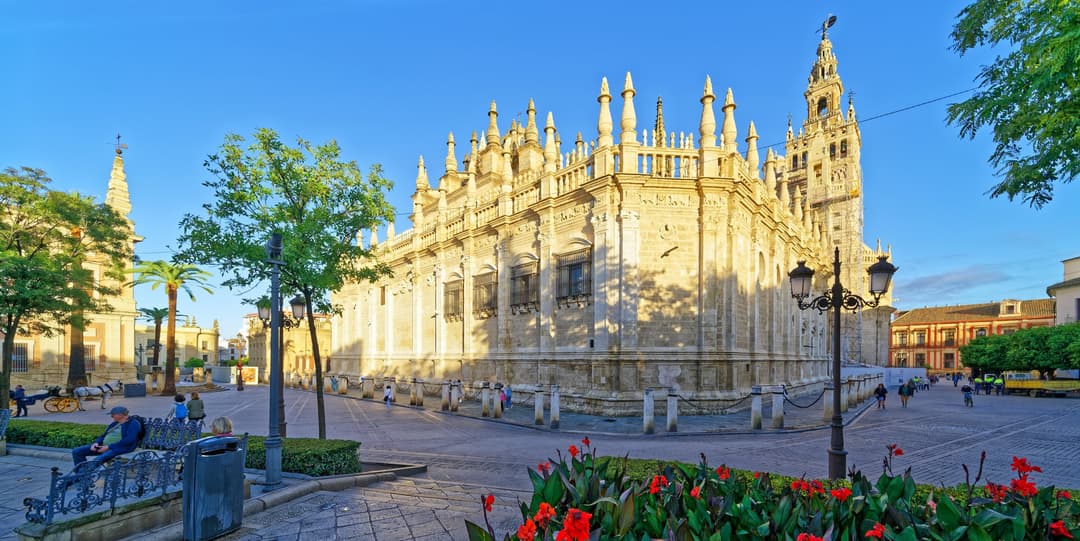 Exterior wide-angle view of Seville Cathedral and the Giralda tower