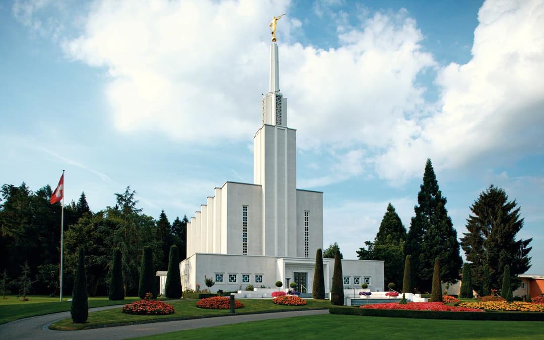 The Bern Switzerland Temple with a statue of the angel Moroni.