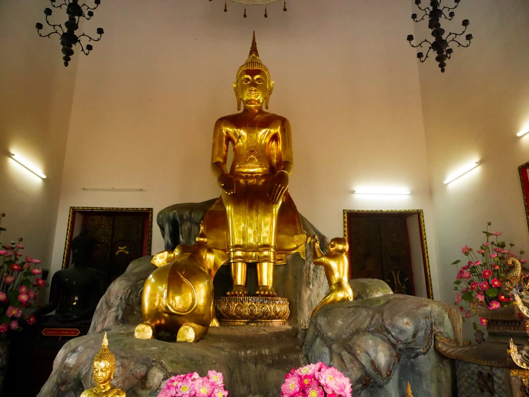 Golden Buddha statue in Palilai posture with elephant and monkey, Wat Pho.