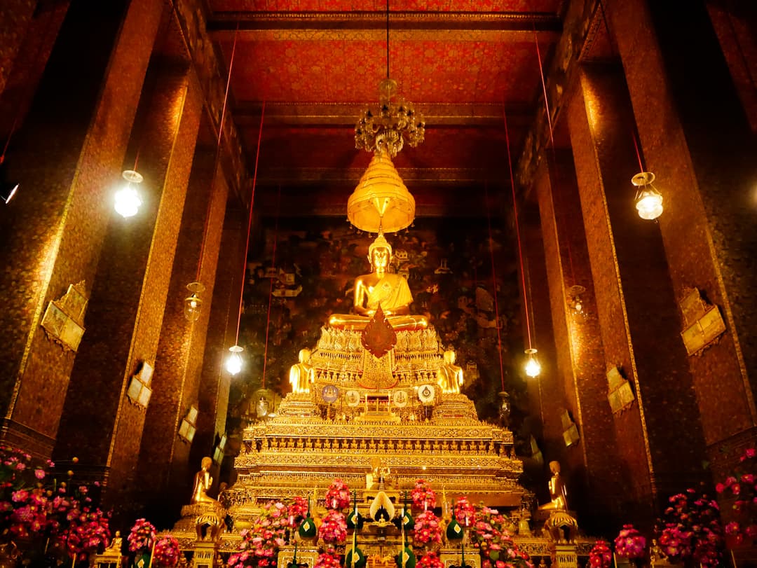 Interior view of the main ordination hall at Wat Pho with golden Buddha.