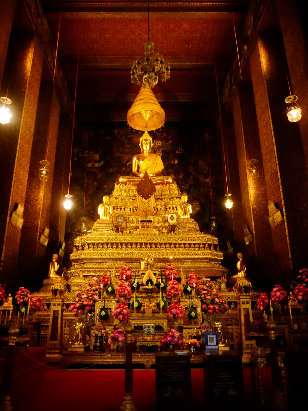 Interior of the Phra Uposatha featuring the main gilded Buddha image at Wat Pho.