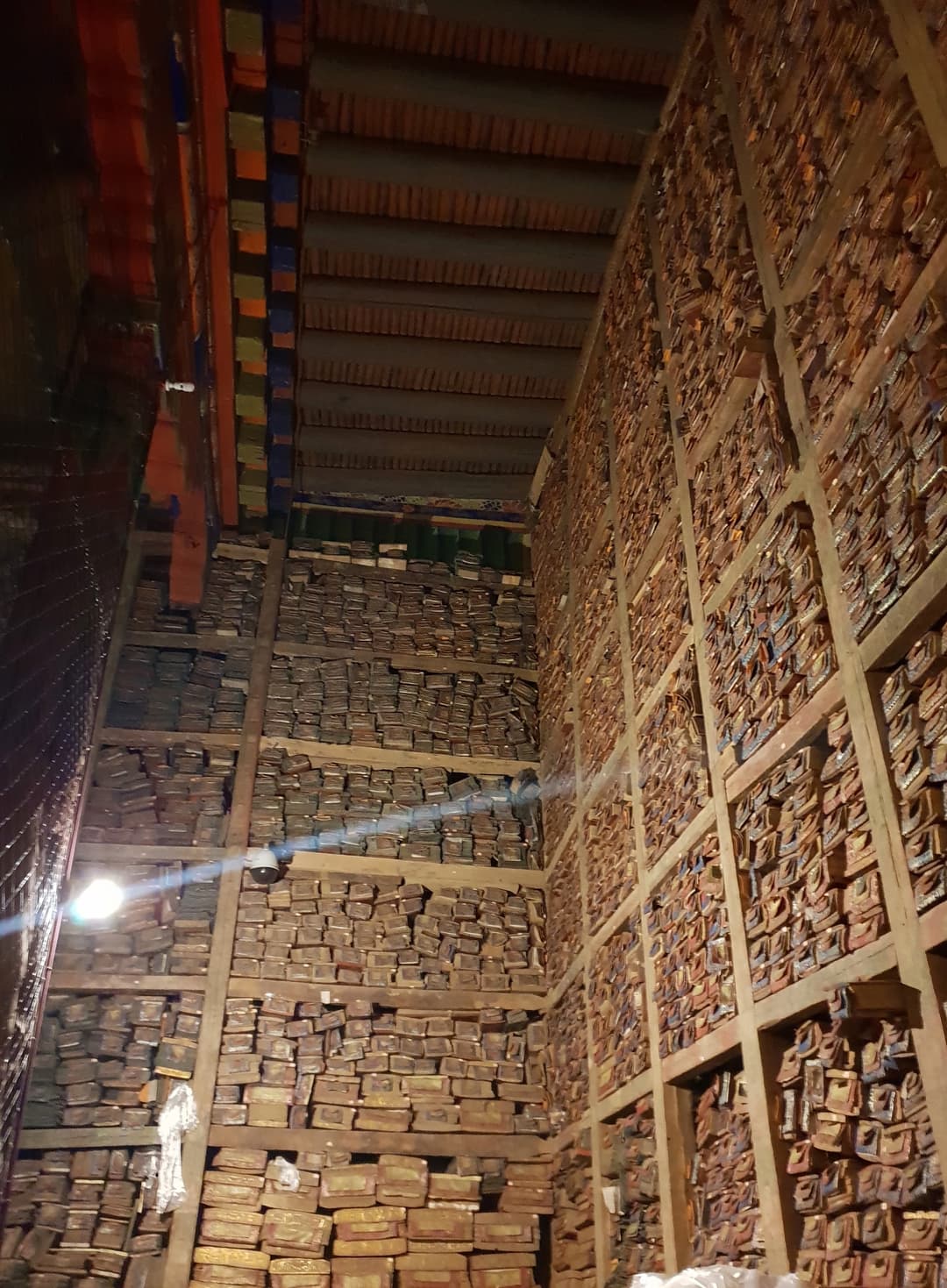 Towering scripture wall of ancient manuscripts in Sakya Monastery library