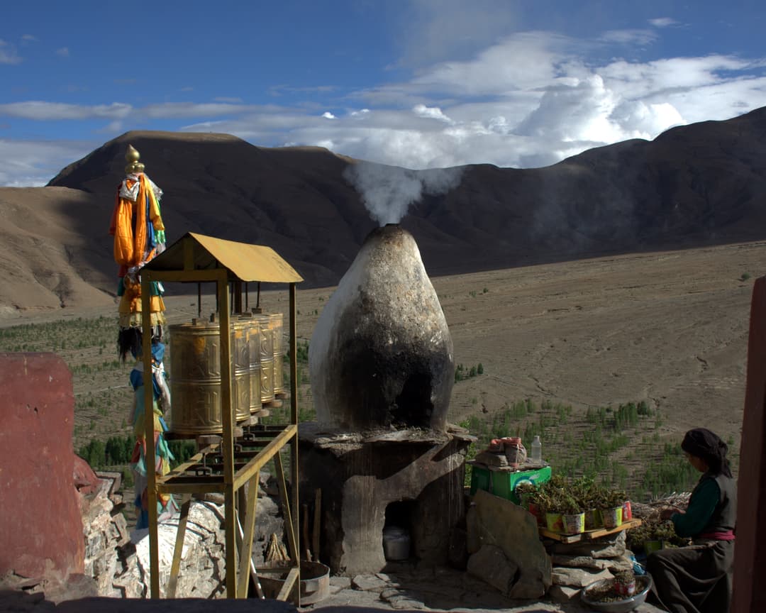 Smoking incense burner and prayer wheels overlooking the valley from Yumbulagang.