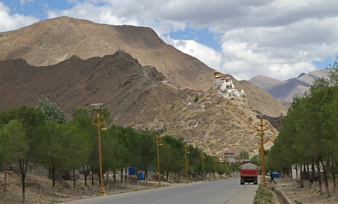 Distant view of Yumbulagang atop Mount Zhaxi Ceri from the approaching road.