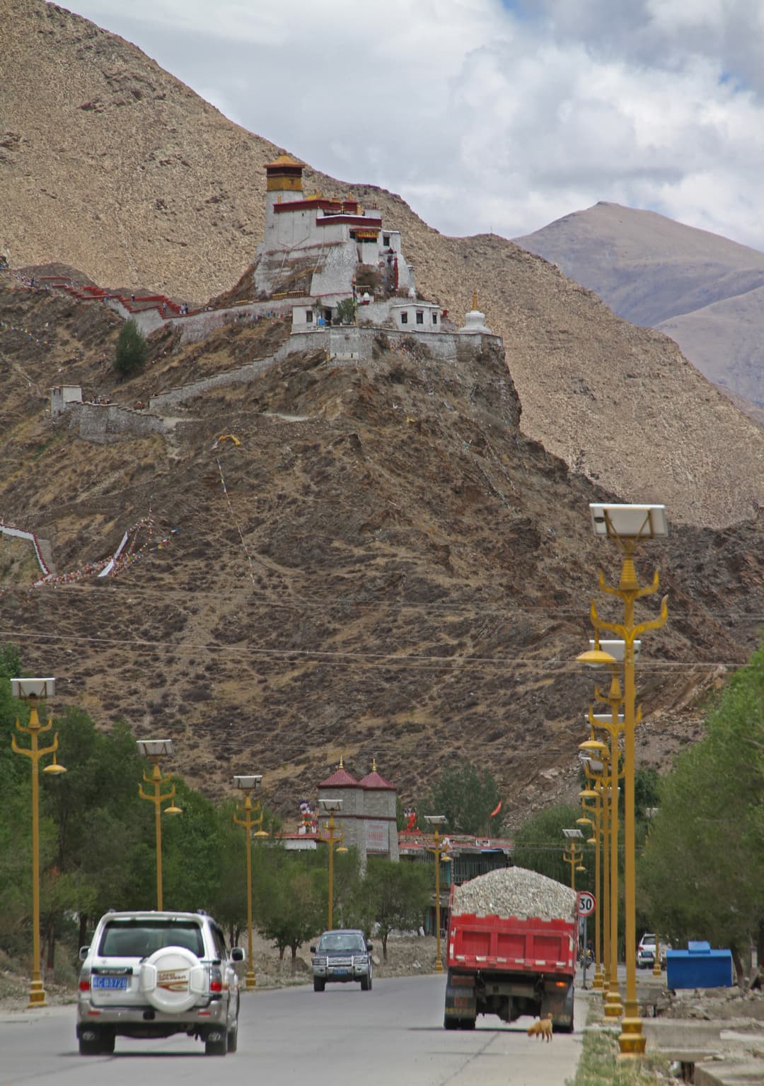Distant view of Yumbulagang atop its rocky hill from the approach road.