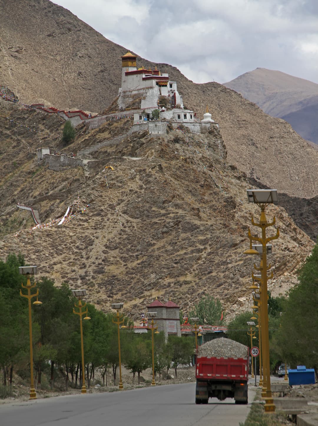 Distant view of Yumbulagang perched on a hill, seen from the road below.