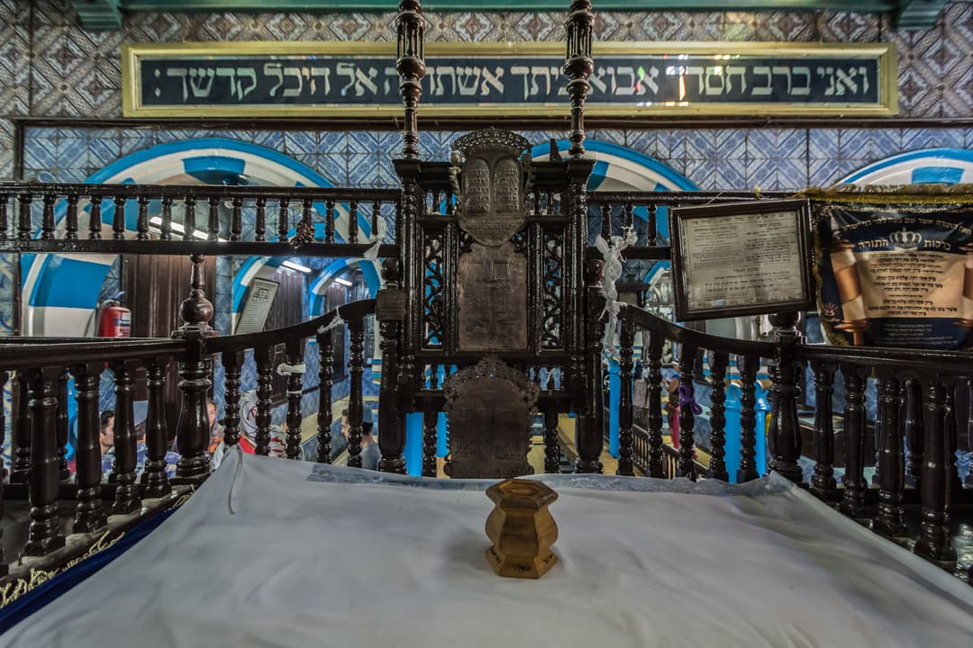 Interior view of the carved wooden bimah at El Ghriba Synagogue