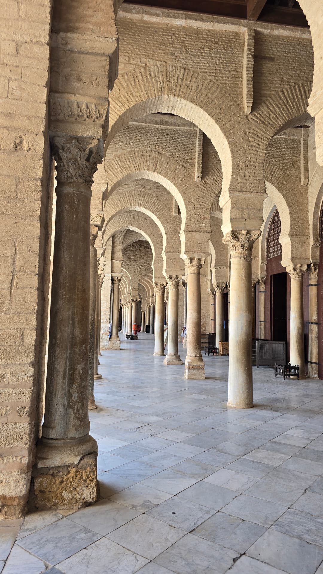 Courtyard portico with horseshoe arches and marble columns