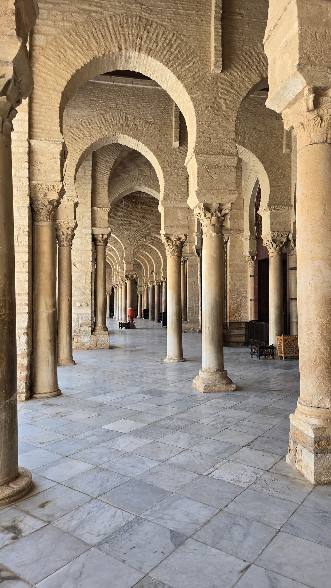 Arcaded courtyard portico with antique columns and horseshoe arches
