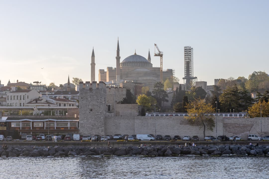 Distant view of Hagia Sophia rising behind the ancient sea walls.