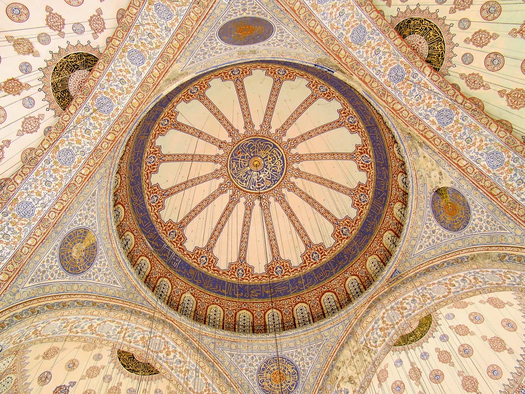 Interior view of the decorated central dome and calligraphy
