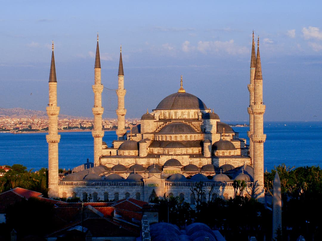 Elevated view of the cascading domes and minarets in warm evening light