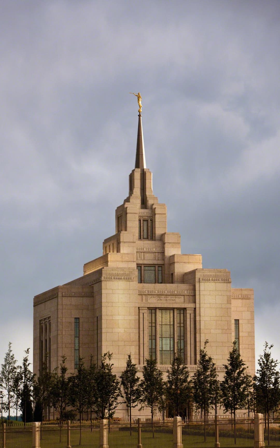 Low-angle view of the Kyiv Ukraine Temple's central spire against a cloudy sky.