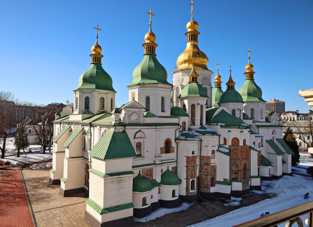 Elevated view of Saint Sophia Cathedral's green and gold domes in winter